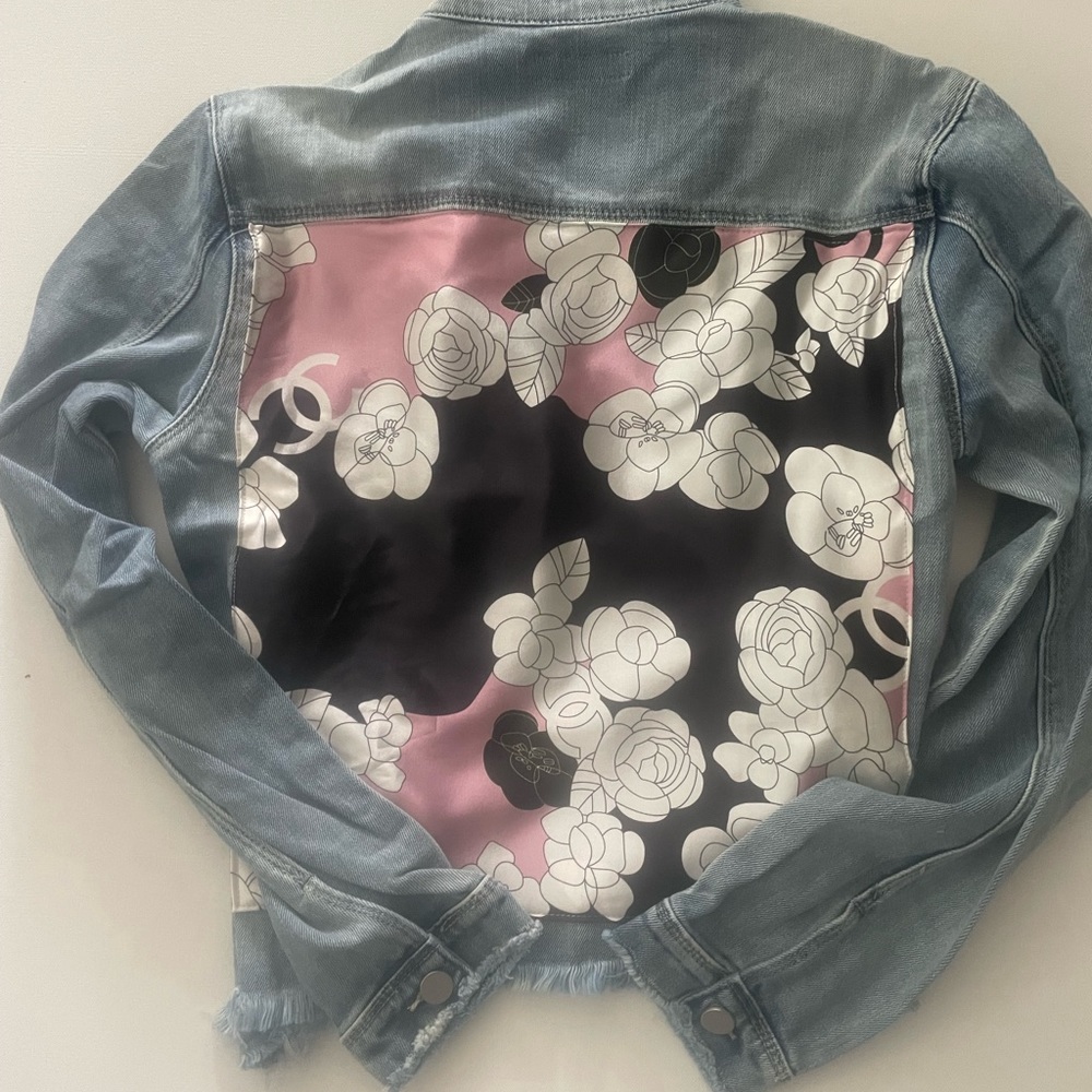 Denim jacket with scarf on the back.